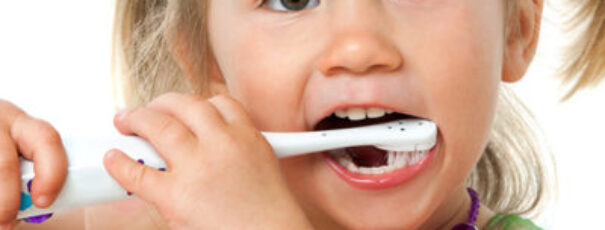 Close Up Portrait Of Cute Girl Brushing Teeth.